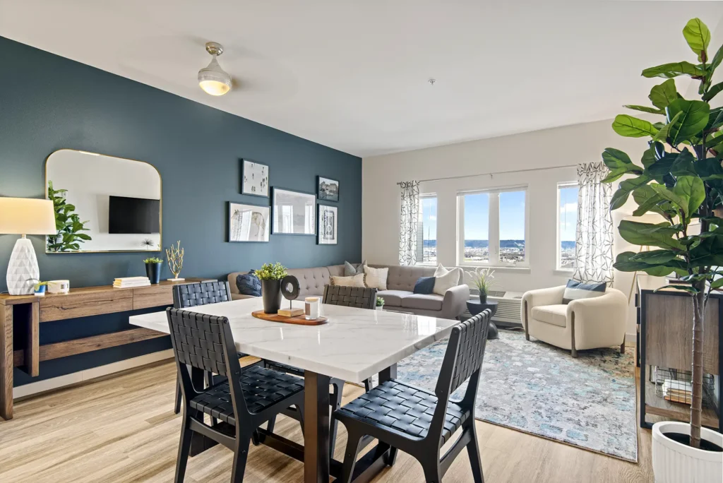 Living room and dining room with blue accent wall at VUE25 pet-friendly apartments in Tacoma, WA