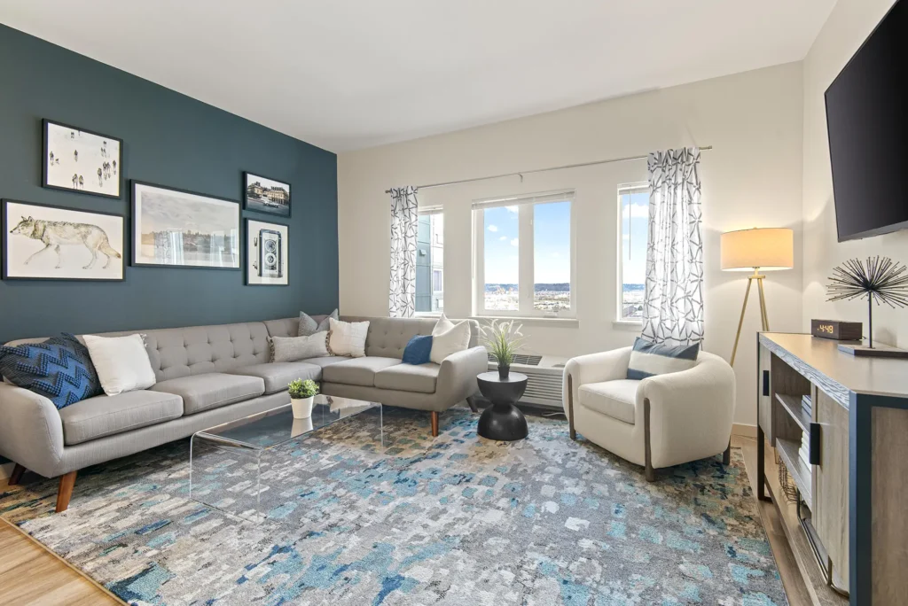 Living room with blue accent wall at VUE25 apartments in Tacoma, WA